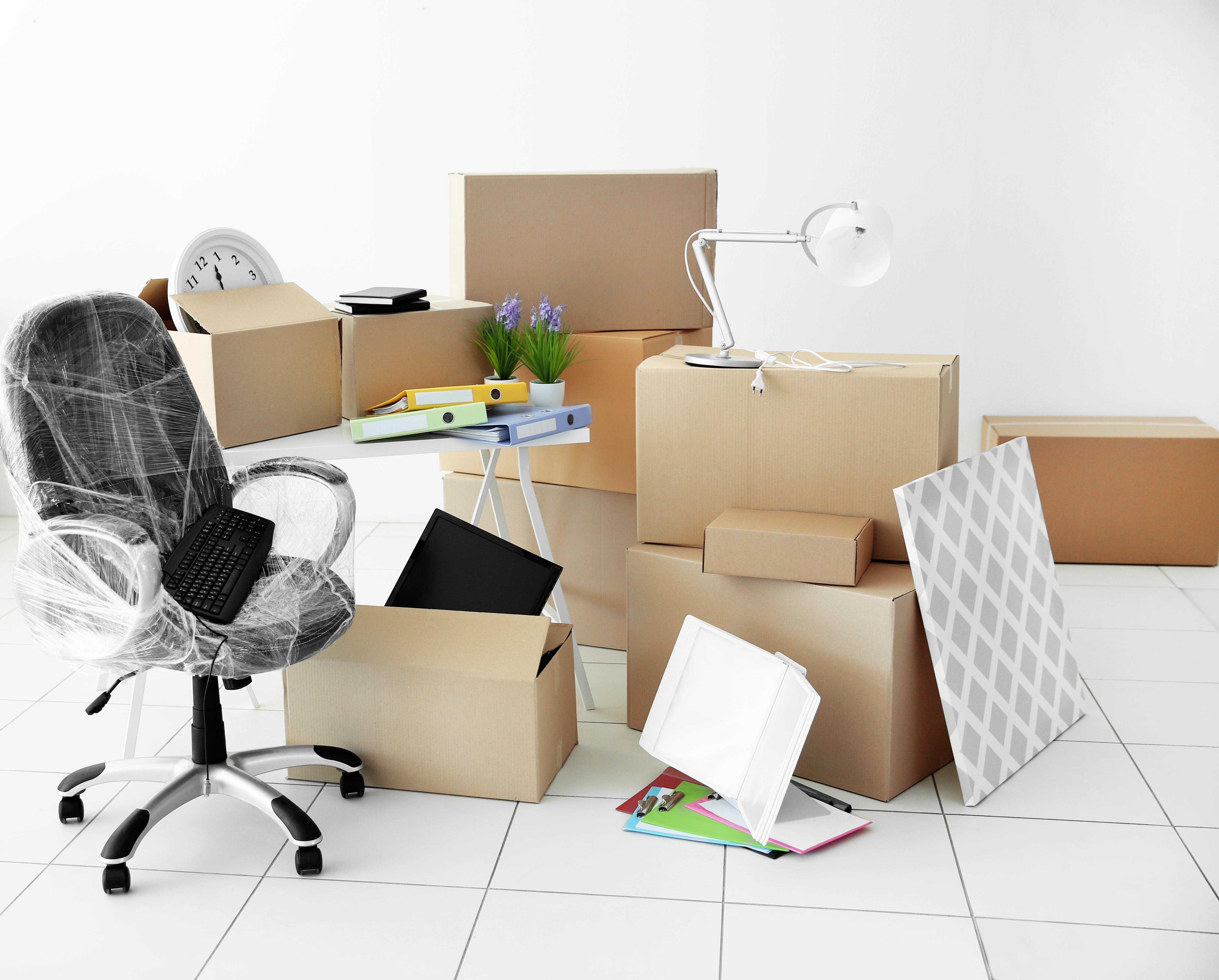 Moving cardboard boxes and personal belongings in empty office space